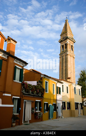 Italia Veneto Laguna di Venezia Isola di Burano campanile pendente della chiesa di San Martino con case colorate in primo piano Foto Stock