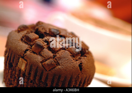 Close-up di un chip di cioccolato muffin con un fuori fuoco sullo sfondo del caffè Foto Stock