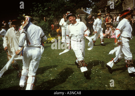 Bampton Morris danzava nei giardini di una "grande" casa del villaggio. 1970 del Regno Unito circa 1975 Un tradizionale rituale di fertilità primaverile inglese. Foto Stock