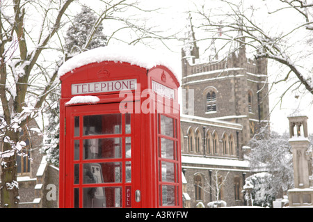 Chiesa Parrocchiale di Santa Maria e il telefono rosso box nella neve Foto Stock