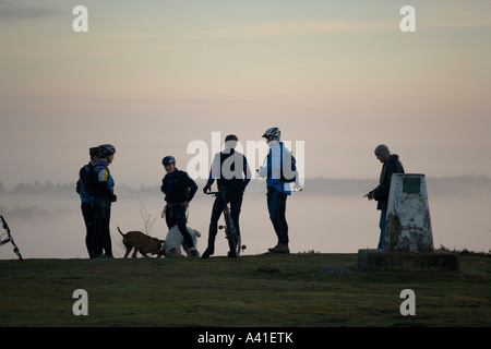 I ciclisti e gli escursionisti chat nelle prime ore del mattino sul patibolo Hill nel Surrey, Inghilterra. Foto Stock