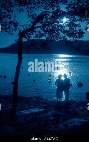 Coppia Matura stagliano contro le acque del Lago Windemere In Cumbria il Lake District. Foto Stock
