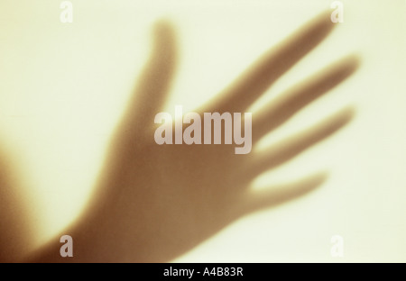 Close up di ombra sul muro di crema di mano gesticulating o enfatizzare o implorando o memoria o scongiurare Foto Stock