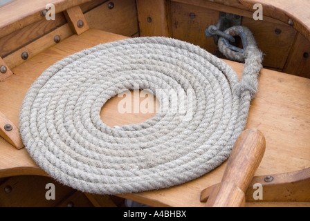 Pittore ben avvolto sulla prua di una piccola barca a vela Foto Stock