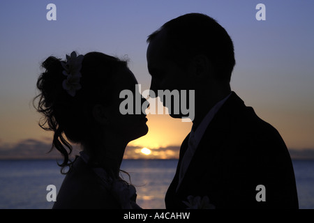 Coppia romantica profilarsi da un tramonto incandescente Foto Stock