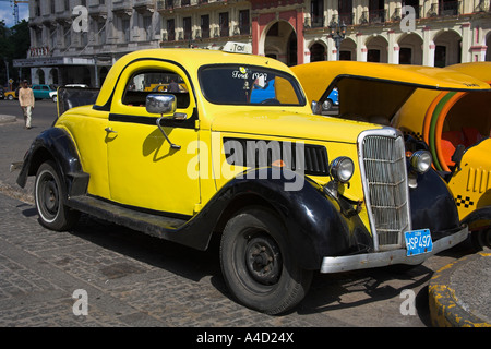 L'annata 1937 americano Ford giallo taxi parcheggiato in strada, l'Avana, La Habana Vieja, Cuba Foto Stock