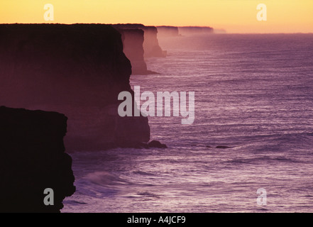 Bunda Cliffs di sunrise eroso Limestone Coast grande insenatura di Australia Australia del Sud con golden spray retroilluminato Foto Stock