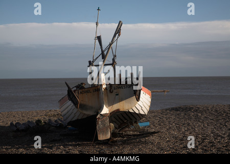 Piccole barche da pesca sulla spiaggia di ciottoli con mare nuvole e cielo blu in background, Sizewell Beach, Suffolk, Inghilterra Foto Stock