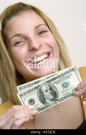 Young woman holding dollar bills close-up Foto Stock