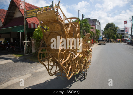 Thailandia venditore ambulante con un sovraccarico trasporto bicicletta artigianale di sedie di vimini, arredamento, design, natura, rattan artigianale di prodotti locali, Foto Stock