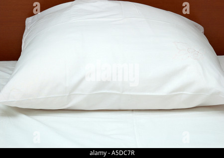 Letto con lenzuola bianche e cuscino close up Foto Stock