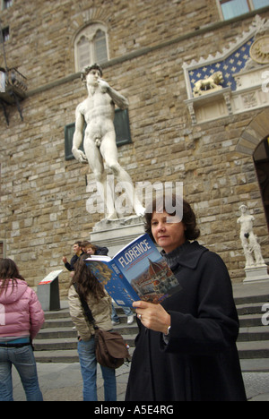 Firenze singolo turista femminile legge guida nella parte anteriore della statua del David Firenze Toscana Italia Foto Stock