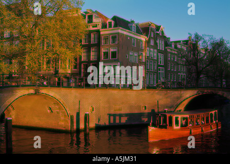 In vecchio stile in legno piccolo canal tour in barca di crociera su una crociera serale sui canali di Amsterdam Paesi Bassi Olanda UE Europa Foto Stock