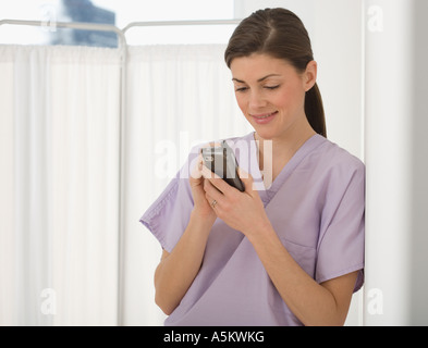 Medico donna guardando all'agenda elettronica Foto Stock