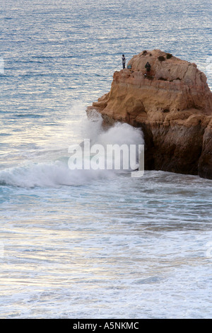 Due pescatori arroccato sulla scogliera a Praia da Rocha Portimao Algarve Portogallo Foto Stock