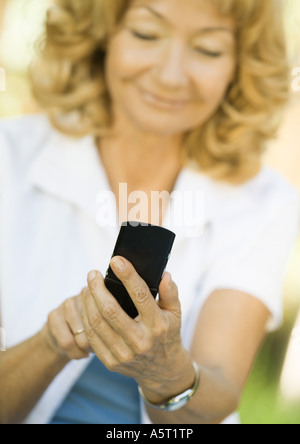 Senior donna tramite telefono cellulare Foto Stock