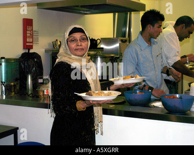 Donna che serve cibo a EID interlocutore St Josephs Church Hall Epsom Surrey in Inghilterra Foto Stock
