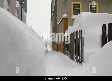 Stretto sentiero innevato tra appartamento case a Oberwiesenthal, Monti Metalliferi, Erz Monti Metalliferi, Bassa Sassonia, Germania Foto Stock