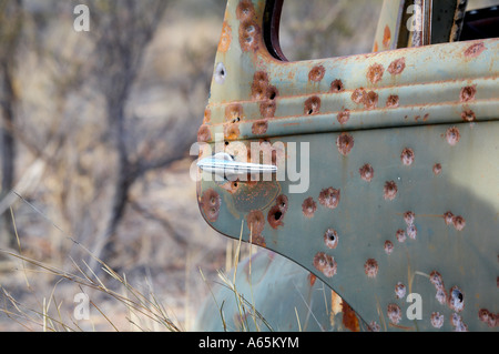 Bullet riddled o fucile eiettato sportello di un auto abbandonate nel bush Australiana Foto Stock
