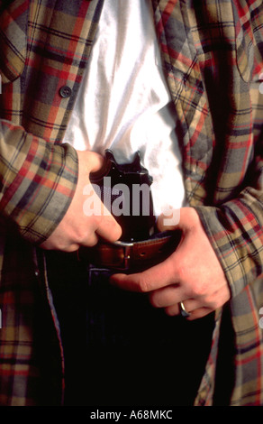 Uomo età 21 tenendo 45 pistola nella sua cinghia (drammatizzazione). St Paul Minnesota USA Foto Stock