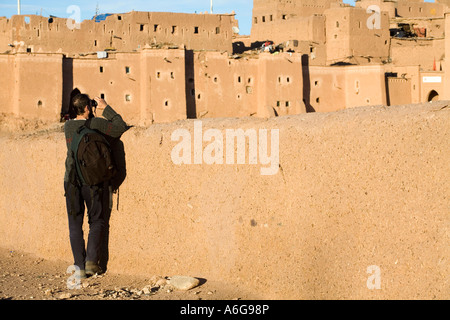 Un turista guarda attraverso il binocolo verso il Taourirt Kasbah di Ouarzazate, Marocco Foto Stock