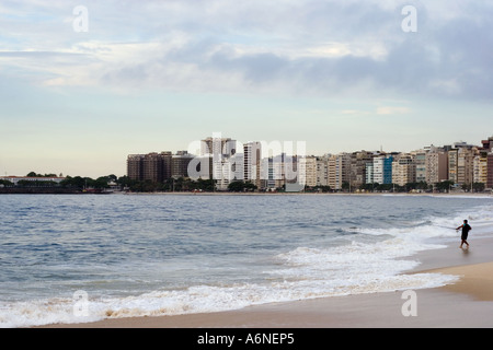 Un uomo locale pesca sulla spiaggia di Copacabana molto presto la mattina Foto Stock