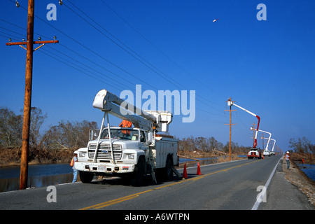 Dopo l'uragano Rita surge devastanti in 2005, gli equipaggi di linea con antenna camion lavorare alla costruzione di nuove linee di trasmissione. Foto Stock