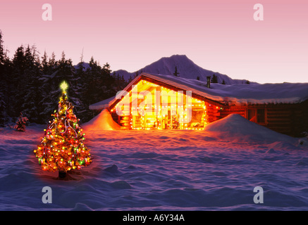 Girdwood Log Cabin le luci di Natale Decorazioni crepuscolo AK centromeridionale inverno Neve Scenic Foto Stock