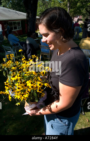 Donna che mantiene un bouquet di black eyed susans. McKinley Wisconsin USA Foto Stock