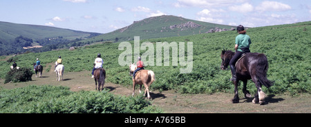 Widecombe nel paesaggio rurale della campagna di Moor Dartmoor, gruppo di persone che camminano in fila attraverso la brughiera aperta giorno estivo soleggiato Devon Inghilterra Regno Unito Foto Stock