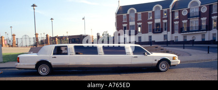 Stretching limousine Close up of long ostentatious chauffeur driven Luxury vehicle white drive on Road a Liverpool Merseyside Inghilterra Regno Unito Foto Stock