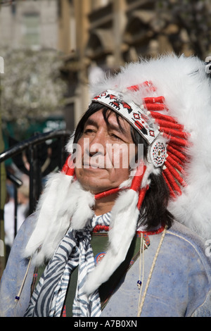 Musicista messicano indiano con la tradizionale headdress etnico piume. Animatore musicale di strada; Dundee City Center, Tayside, Scozia UK Foto Stock