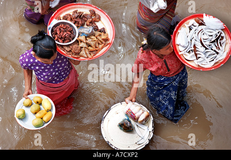 Le donne che vendono alimenti da piatti e vassoi di passeggeri su una barca che passa lungo il tragitto da Mandalay a Bagan Birmania Myanmar Foto Stock