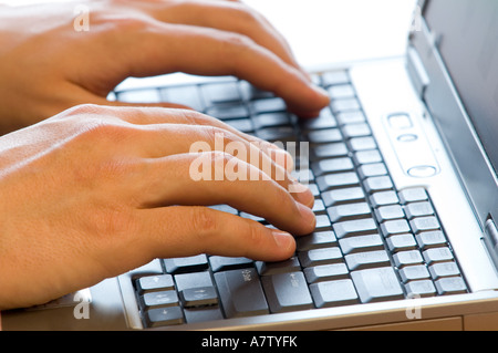 Maschio di mani su di una tastiera di un computer portatile Foto Stock
