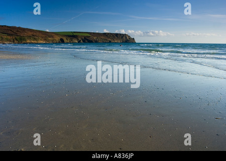 Cielo blu riflessa nella sabbia bagnata sulla carne Beach Cornwall Regno Unito con testa nsono in background Foto Stock