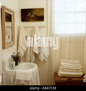 La tendina di pizzo in bagno bianco con tendina sotto lavandino e  asciugamani su pegrail Foto stock - Alamy
