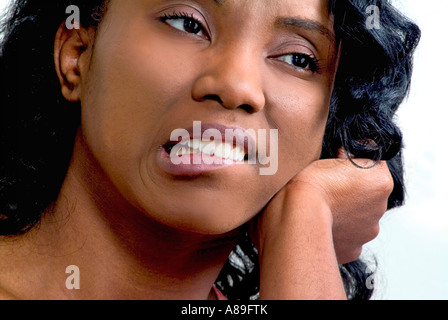 Visualizzazione verticale di un grazioso insoddisfatti etnico africano nero donna americana con una triste espressione facciale Foto Stock