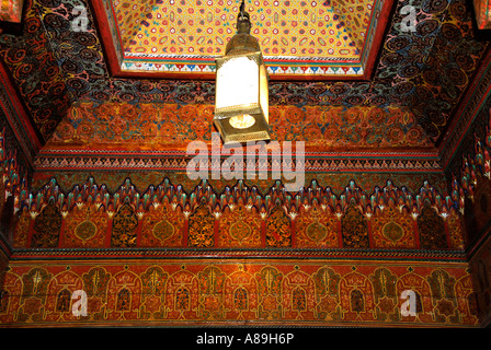 Raffinati dipinti a soffitto in legno con lampada al Palais de la Bahia Marrakech marocco Foto Stock