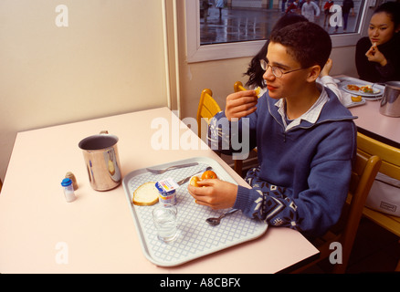 Marcq en Baroeul Francia ragazzo di mangiare il pranzo in mensa Ecole J Manuel Foto Stock