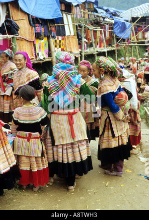 Gruppo di tradizionalmente condita Flower Hmong donne e una giovane ragazza presso il mercato del sabato, può cau, NW Viet Nam Foto Stock