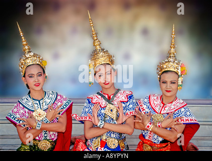 Tre giovani femmine tailandese tradizionale ballerini classici dimostrando il braccio e la mano i movimenti delle dita nel tempio Wat Ratchanatdaram, Bangkok, Thailandia Foto Stock