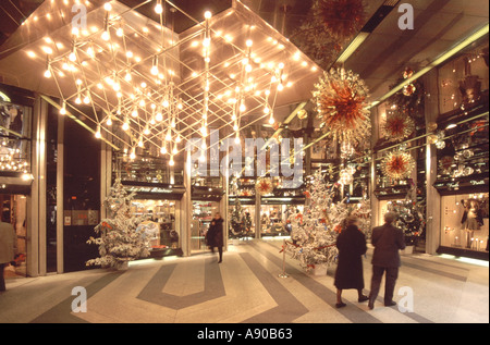 Parigi persone shopping interni negozi francesi negozi arcade al largo degli Champs Elysees con decorazioni natalizie e illuminazione Francia Europa Foto Stock