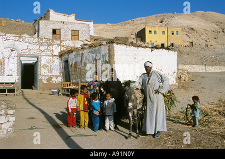 Ritratto di un tradizionale rurale famiglia egiziana in piedi accanto a casa, nei pressi di Luxor, Egitto Foto Stock