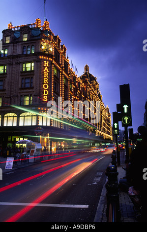 I percorsi del traffico presso i famosi magazzini Harrods accesa fino al tramonto nella città di Londra Inghilterra REGNO UNITO Foto Stock