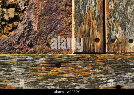 Dettaglio che mostra i colori e le trame di weathered tavole di legno e metallo arrugginito. close up Foto Stock