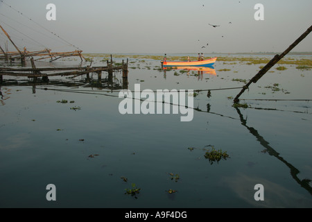 Fisherman lasciare il mercato per andare a pesca passato i cinesi reti da pesca a Kochi (Cochin), Kerala, India del Sud Foto Stock