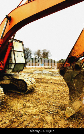 L'escavatore arancione sta aprendo un nuovo cantiere nel Regno Unito Foto Stock