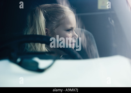 Una ragazza seduta all'interno di un automobile Foto Stock