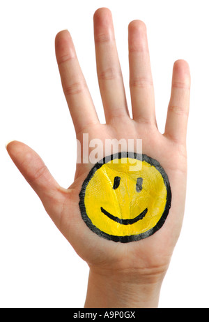 Mano con una felice Smiley face Foto Stock