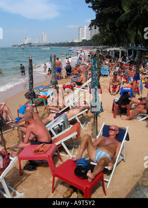 Turisti maschio relax e bagni di sole sulla spiaggia di Pattaya Thailandia Foto Stock